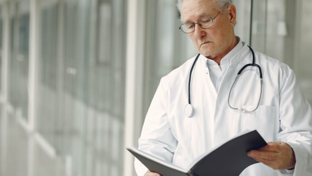 Doctor reads clinical records.