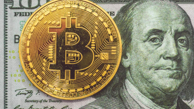 Bitcoin on hundred dollar bill.