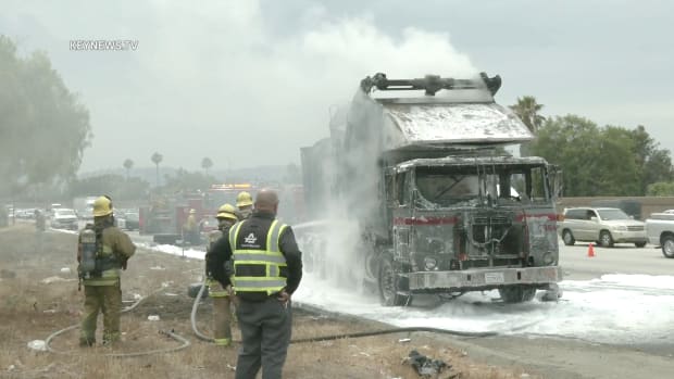 Firefighters Extinguish Trash Truck Fire