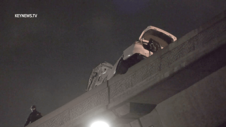 2-Vehicle Crash, 1 Hanging over 110 Expressway Bridge