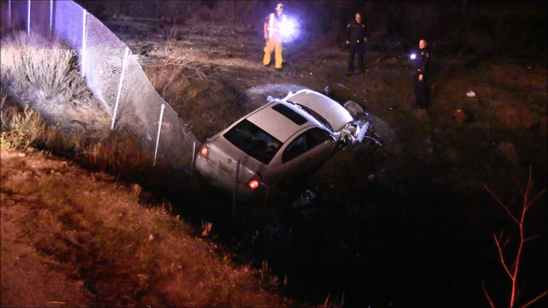 Vehicle Exiting 14 Freeway Lands over Fence