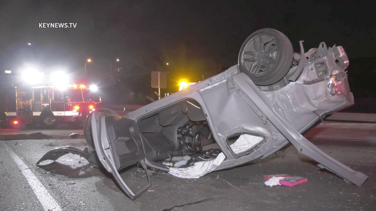 Vehicle Rollover Traps 2 People off 10 Freeway