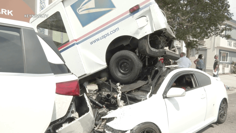 United States Postal Service Truck Crashes, Lands on Parked Vehicles in Valley Village