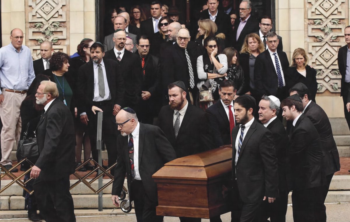 A casket is carried out of Rodef Shalom Congregation after the funeral services for brothers Cecil and David Rosenthal.