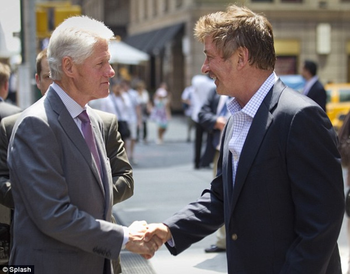 Bill Clinton and Alec Baldwin share a masonic handshake