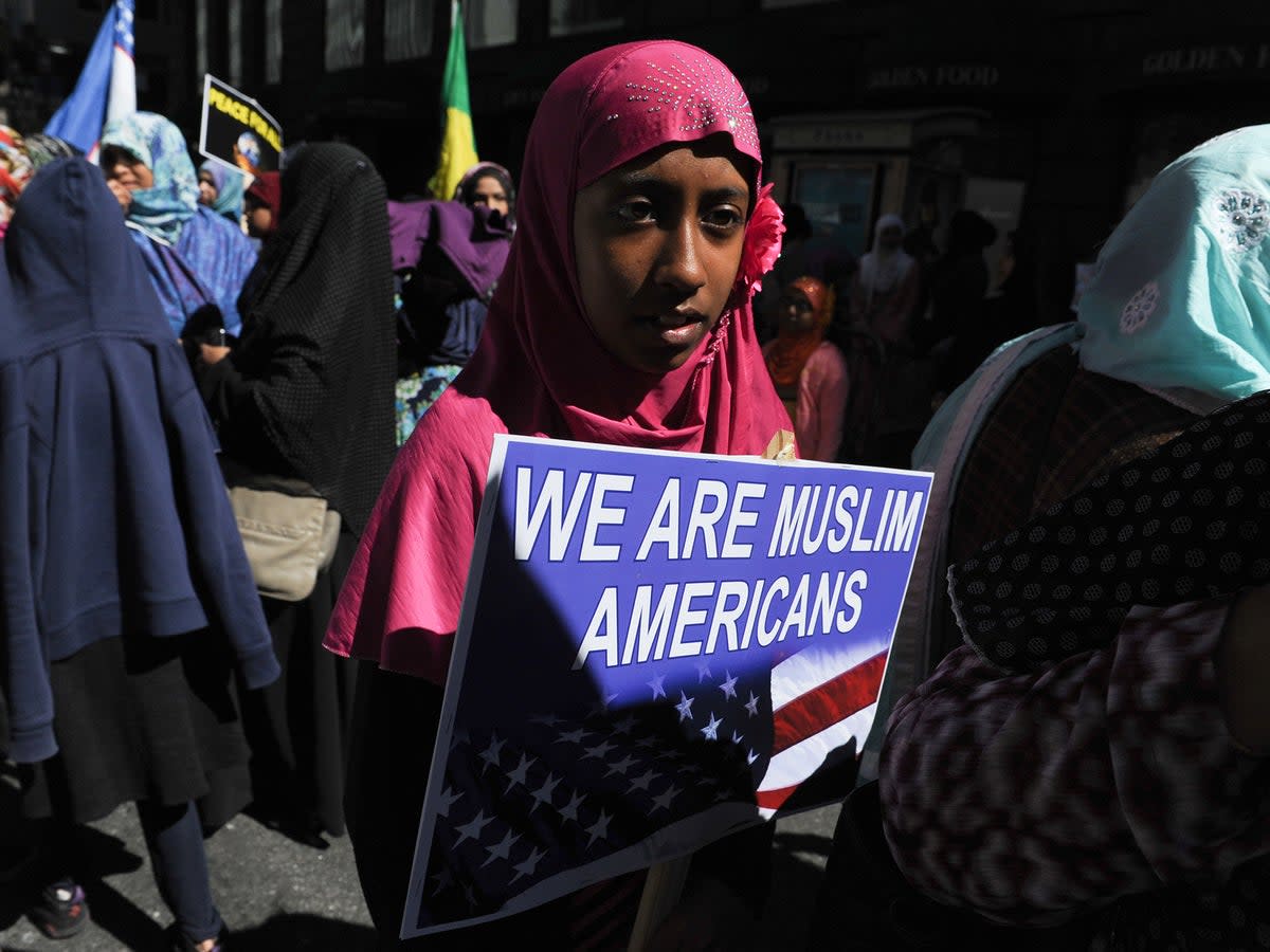 A girl holds a sign during the annual Muslim Day Parade in Manhattan.