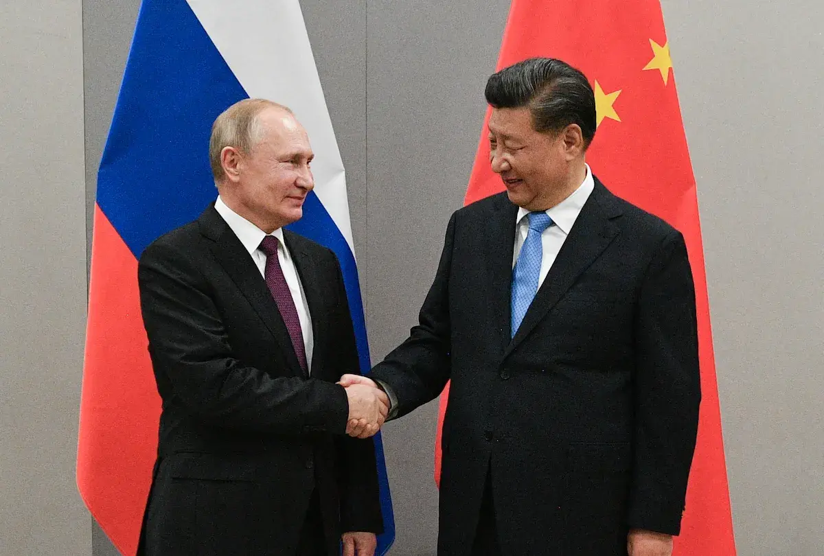 Chinese President Xi Jinping shakes hands with Russian President Vladimir Putin during a meeting on the sidelines of the 11th BRICS Summit, in Brasilia in 2019. Photo: Sputnik / Ramil Sitdikov / via AFP